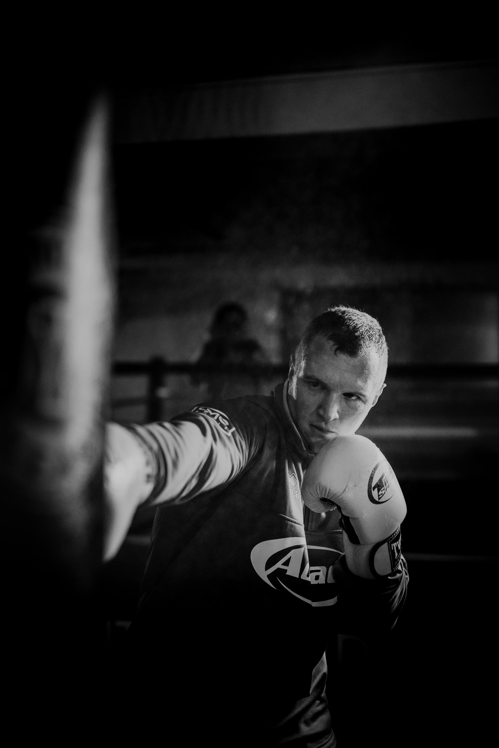 Coach holding pads for a fighter working combinations