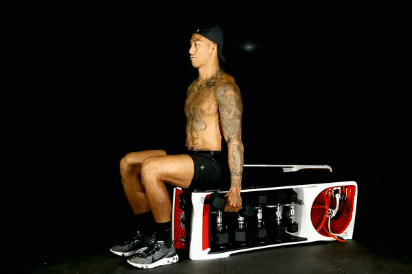 Coach guiding strength block on training floor